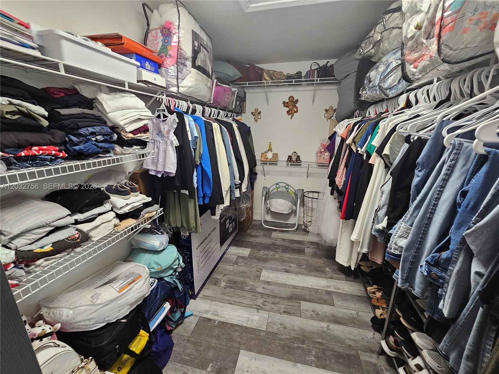 4331 Southwest 124th Way Miramar, FL 33027 - Photo 12 of 40 a view of walk in closet with clothes and shoes
