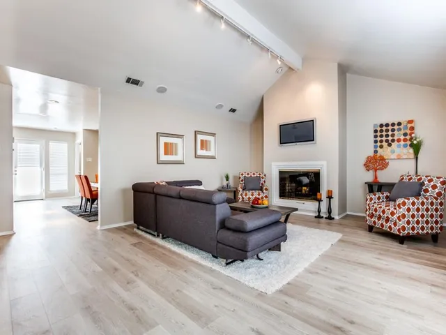 a living room with furniture and a fireplace