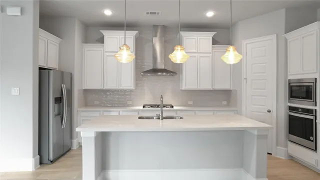 a kitchen with a sink stainless steel appliances and cabinets