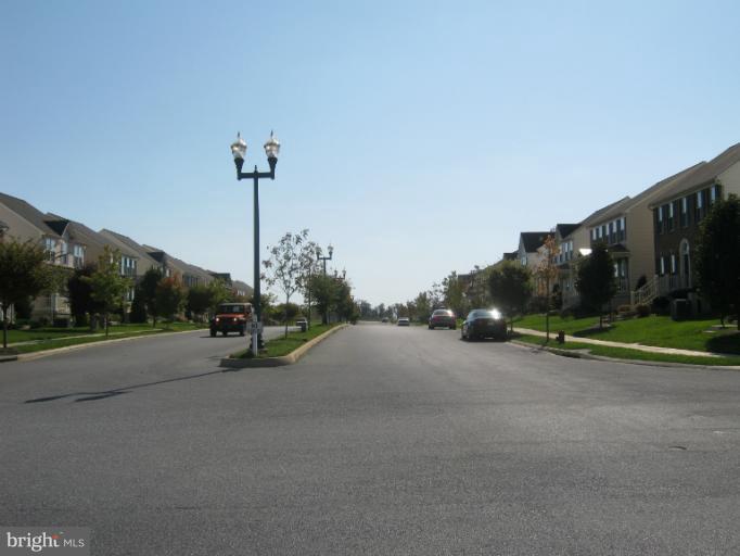 a view of a street with a building and a street sign