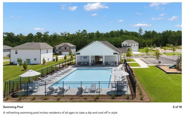a view of a swimming pool and lounge chairs