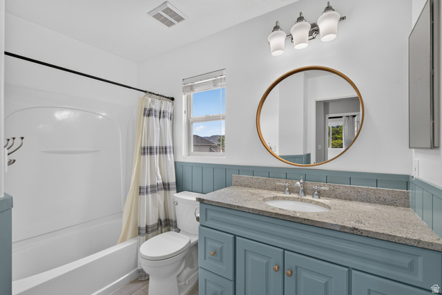 2223 North Pointe Meadow Loop Lehi, UT 84048 - Photo 28 of 56 Bathroom featuring a blue paneled vanity with a light-colored countertop and undermount sink, illuminated by a three-light vanity fixture