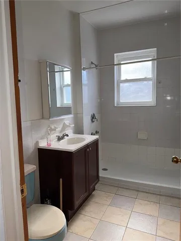 a bathroom with a sink a toilet and mirror