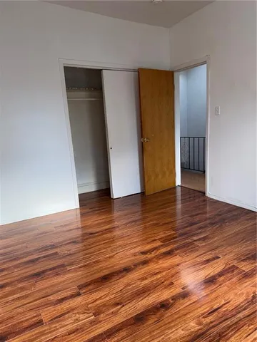 a view of a room with wooden floor and entryway