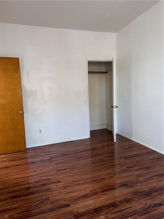 1362 68th Street Brooklyn, NY 11219 - Photo 8 of 11 a view of an empty room with wooden floor and a window