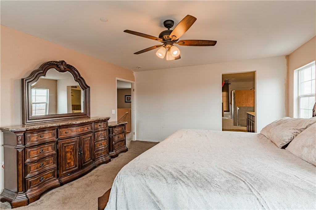 2090 Trinket Circle San Jacinto, CA 92582 - Photo 19 of 43 a bedroom with a bed and a chandelier