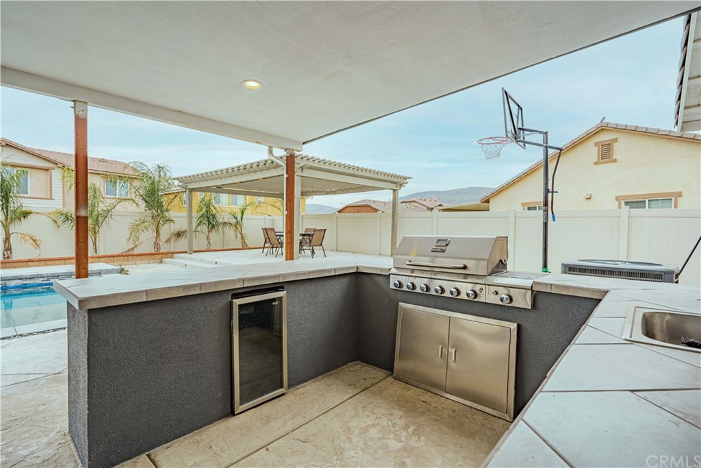 2090 Trinket Circle San Jacinto, CA 92582 - Photo 35 of 43 a kitchen with a sink and a stove top oven
