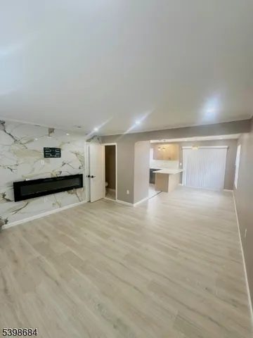 a view of a kitchen with a sink and a refrigerator
