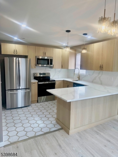 239 40th Street, Unit 7 Irvington, NJ 07111 - Photo 3 of 11 a kitchen with stainless steel appliances granite countertop a refrigerator a stove a sink and a microwave