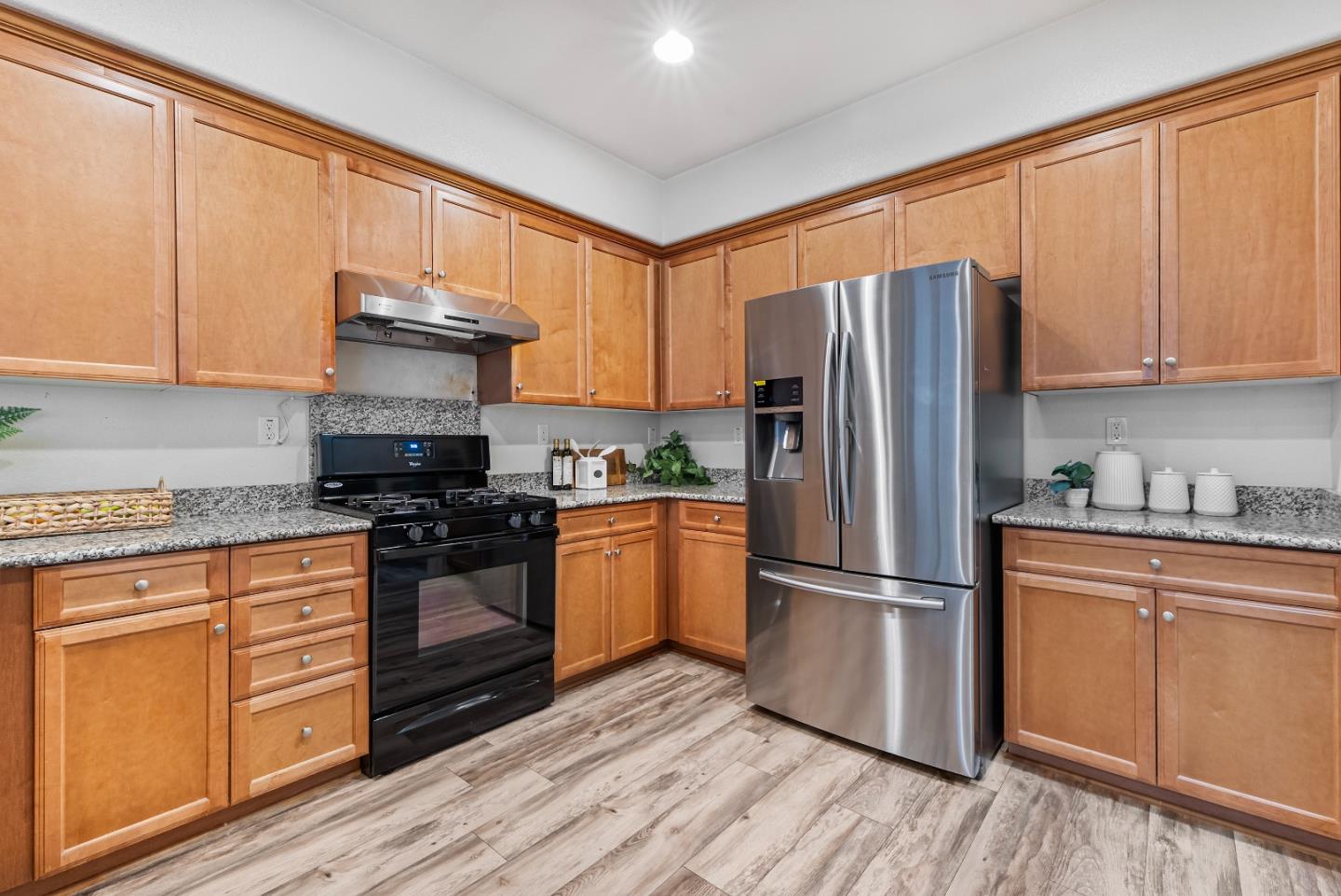 1088 Mallow Terrace San Jose, CA 95133 - Photo 11 of 36 a kitchen with stainless steel appliances granite countertop a refrigerator stove and sink
