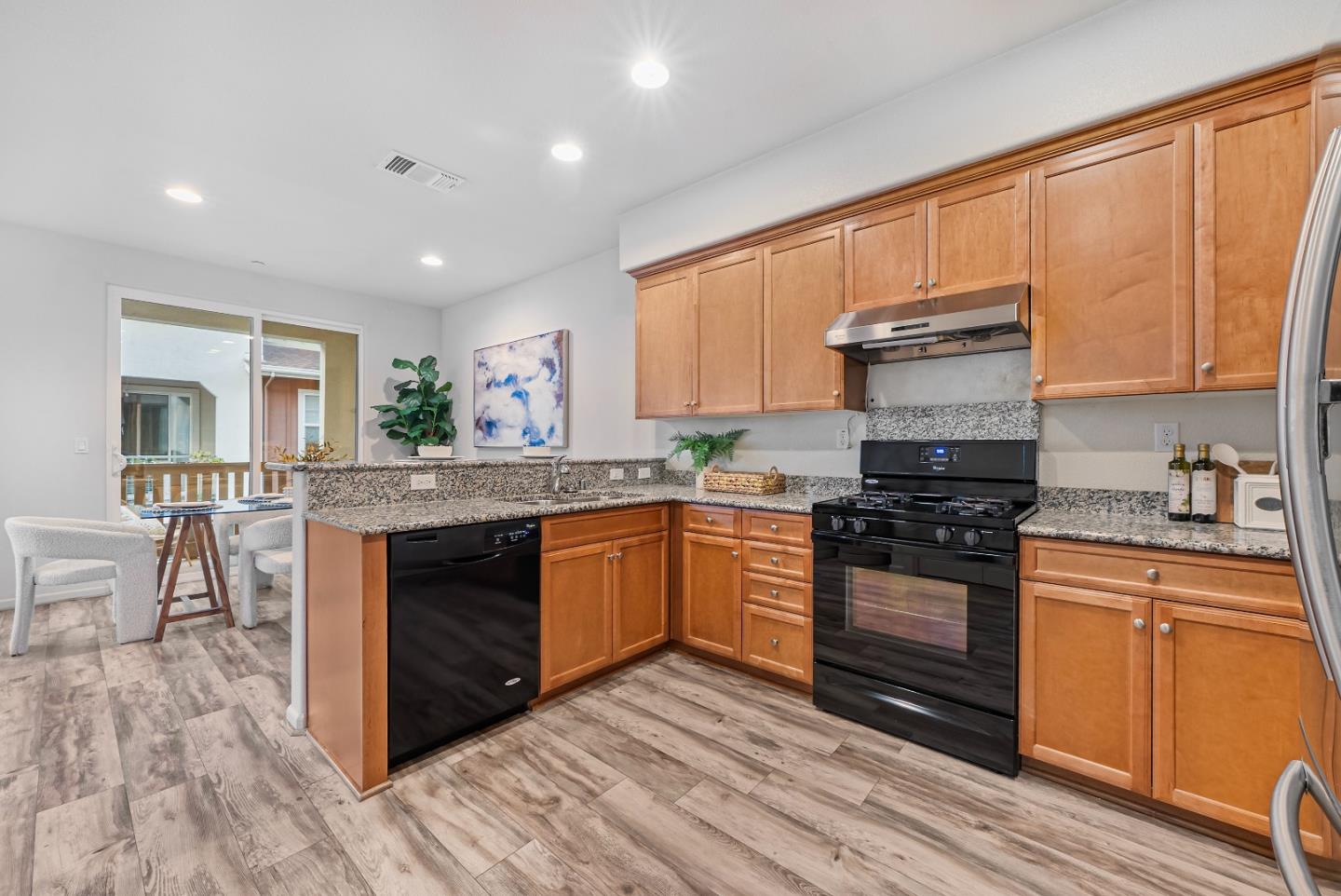 1088 Mallow Terrace San Jose, CA 95133 - Photo 12 of 36 a kitchen with granite countertop a stove top oven sink and cabinets