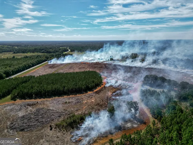 a view of a lake with beach and outdoor space