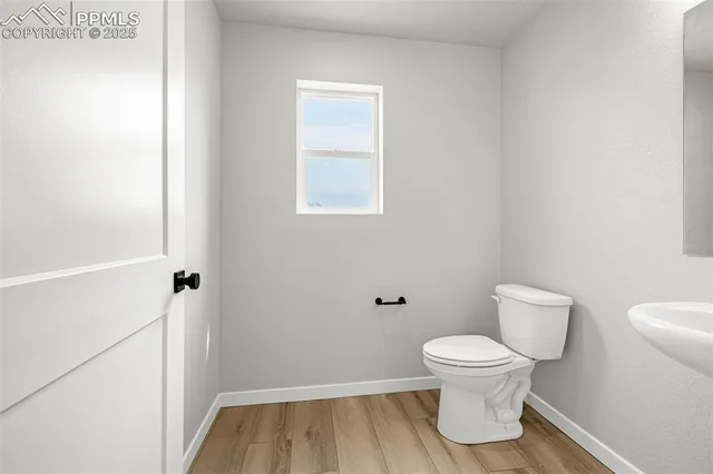 a white toilet sitting next to a bathroom sink
