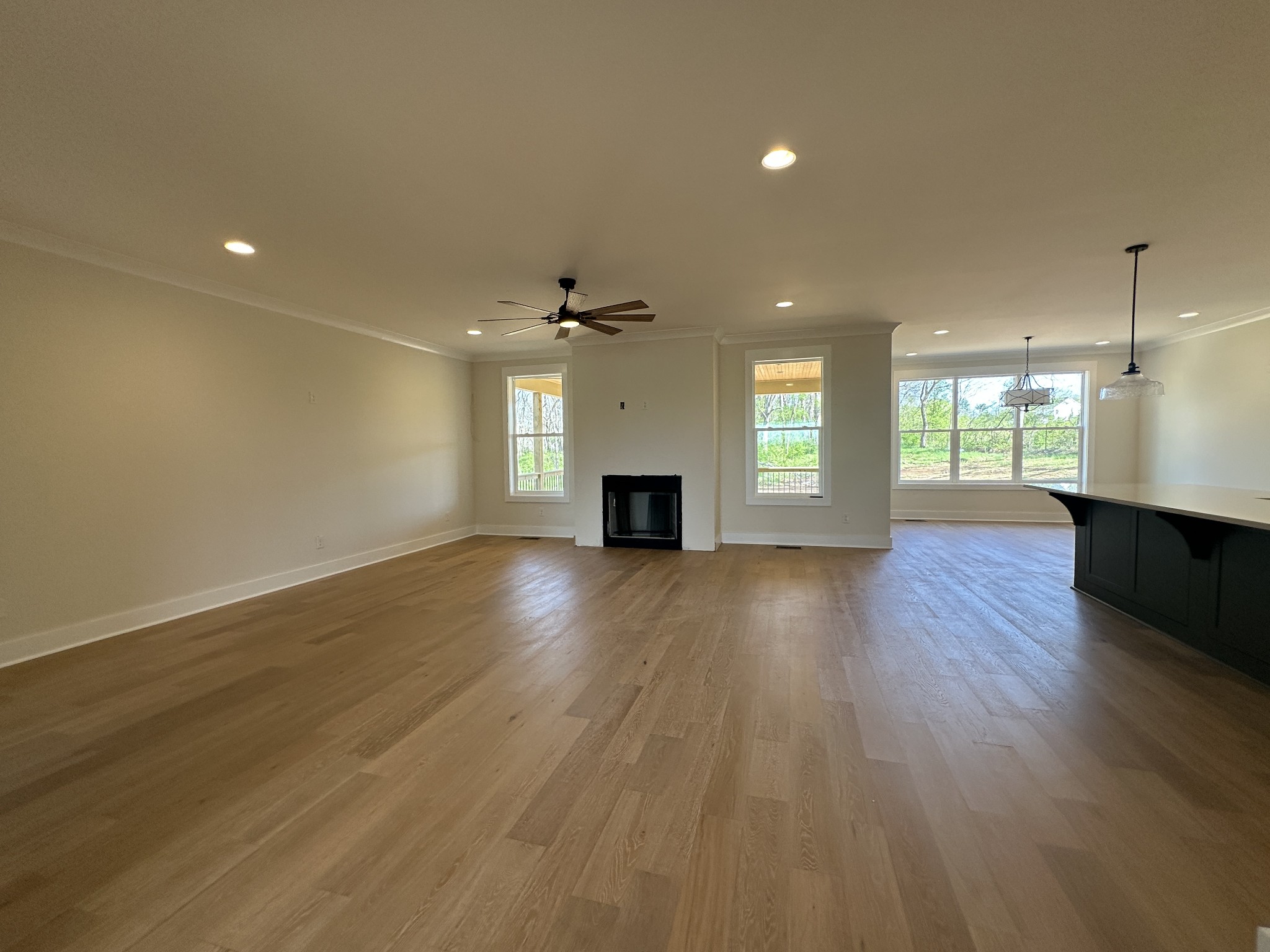 1576 Frye Road Columbia, TN 38401 - Photo 31 of 66 an empty room with wooden floor and a kitchen