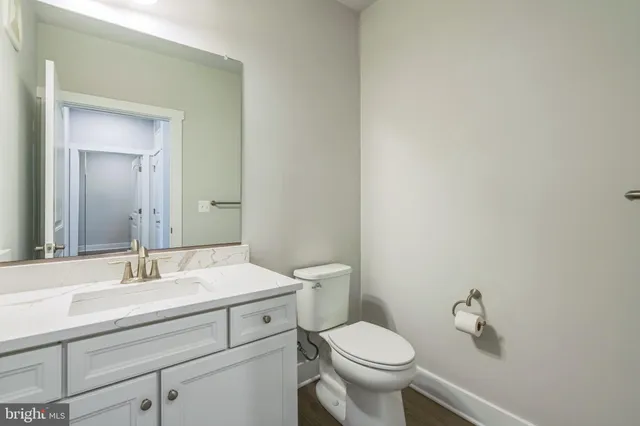 a bathroom with a sink a toilet and a mirror