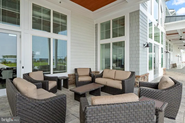 a building outdoor space with patio couches and a potted plant