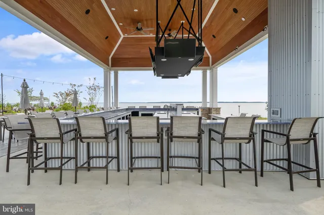 a group of chairs sitting in patio and a yard