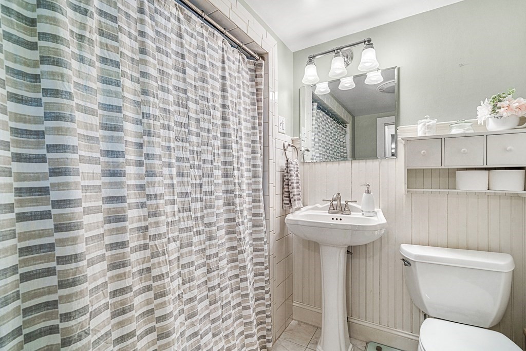 52 Morton Street Andover, MA 01810 - Photo 18 of 27 a bathroom with a sink a toilet and mirror