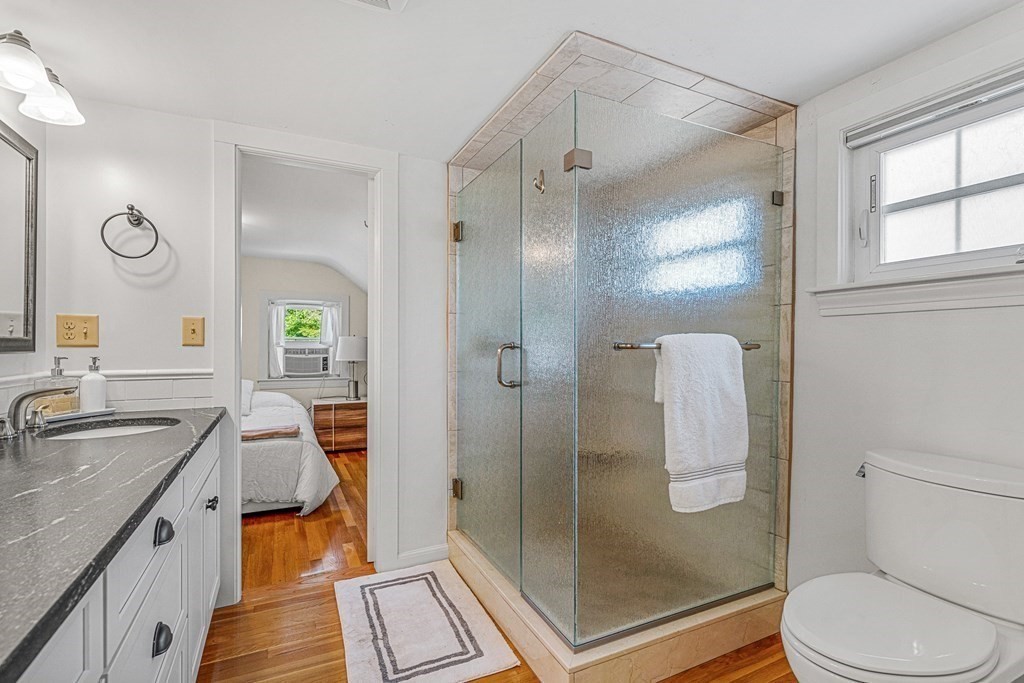 52 Morton Street Andover, MA 01810 - Photo 22 of 27 a bathroom with a sink a toilet a mirror and shower