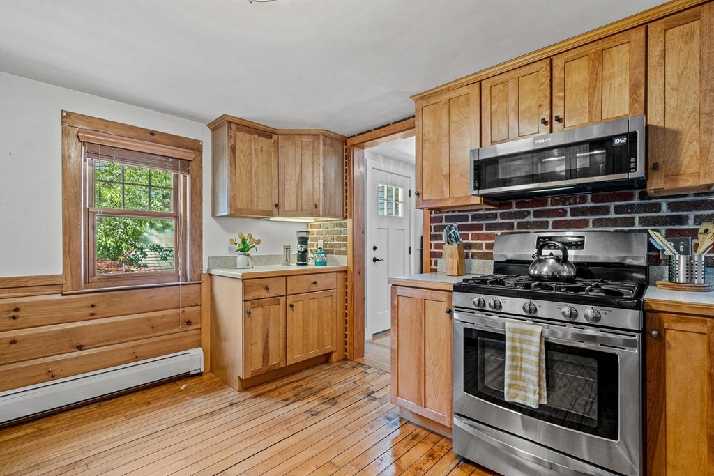 52 Morton Street Andover, MA 01810 - Photo 5 of 27 a kitchen with stainless steel appliances a stove a sink and a microwave