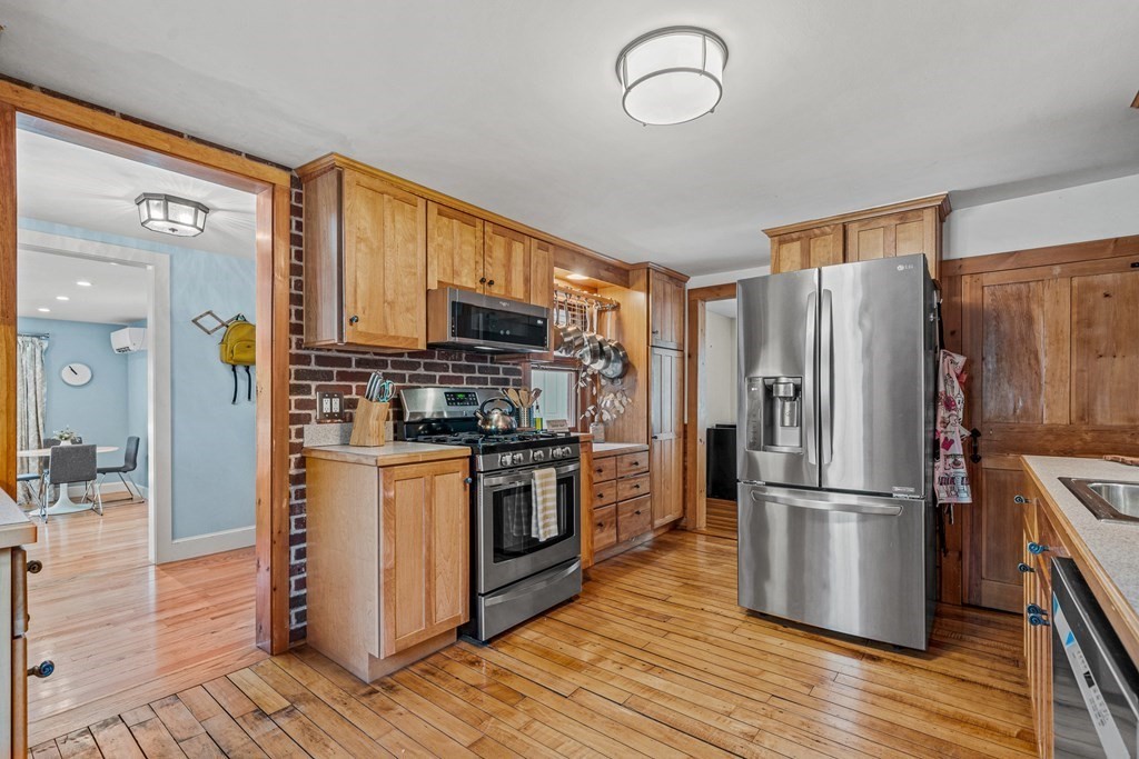 52 Morton Street Andover, MA 01810 - Photo 6 of 27 a kitchen with stainless steel appliances a refrigerator stove and microwave
