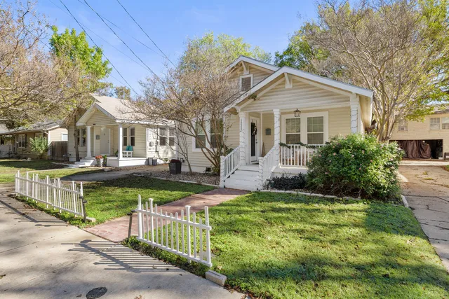 a front view of a house with a garden and plants