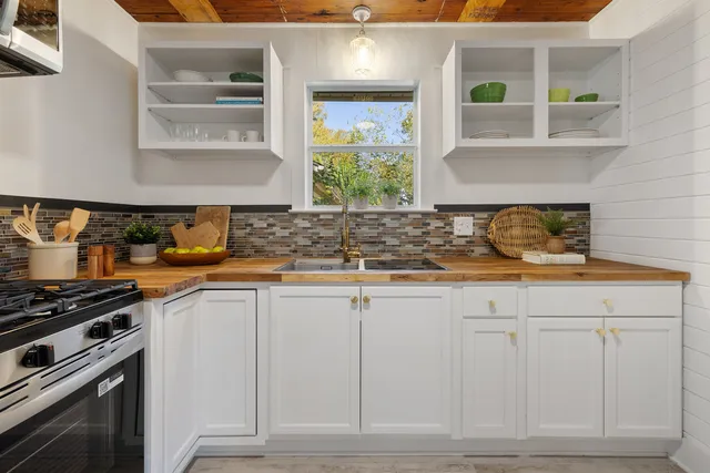 a kitchen with stainless steel appliances granite countertop a sink and a stove
