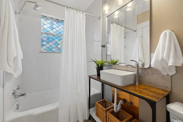 a bathroom with a sink a mirror and a shower