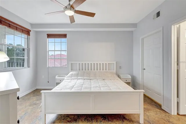 a bed sitting in a bedroom next to a window