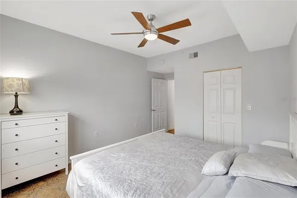 a bedroom with a bed and a ceiling fan