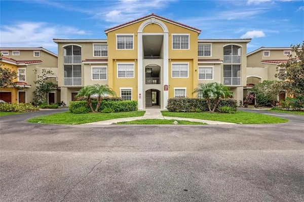 a front view of a residential apartment building with a yard