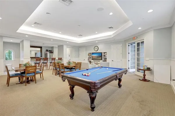 a living room with furniture a table and gym equipment
