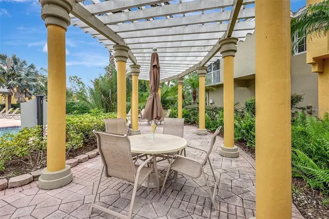 a view of a patio with a table and chairs and potted plants