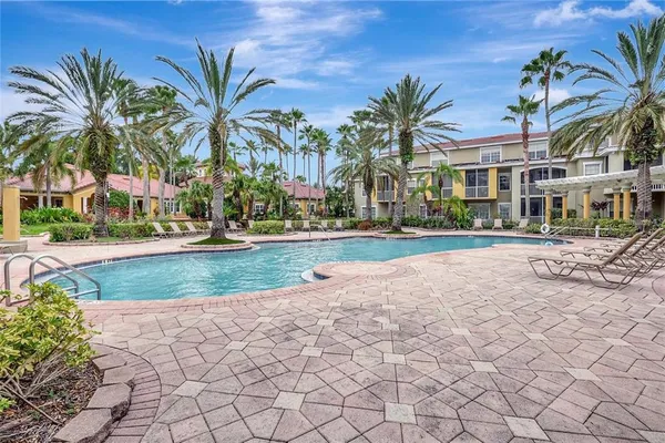 a view of a white house with a yard and plants