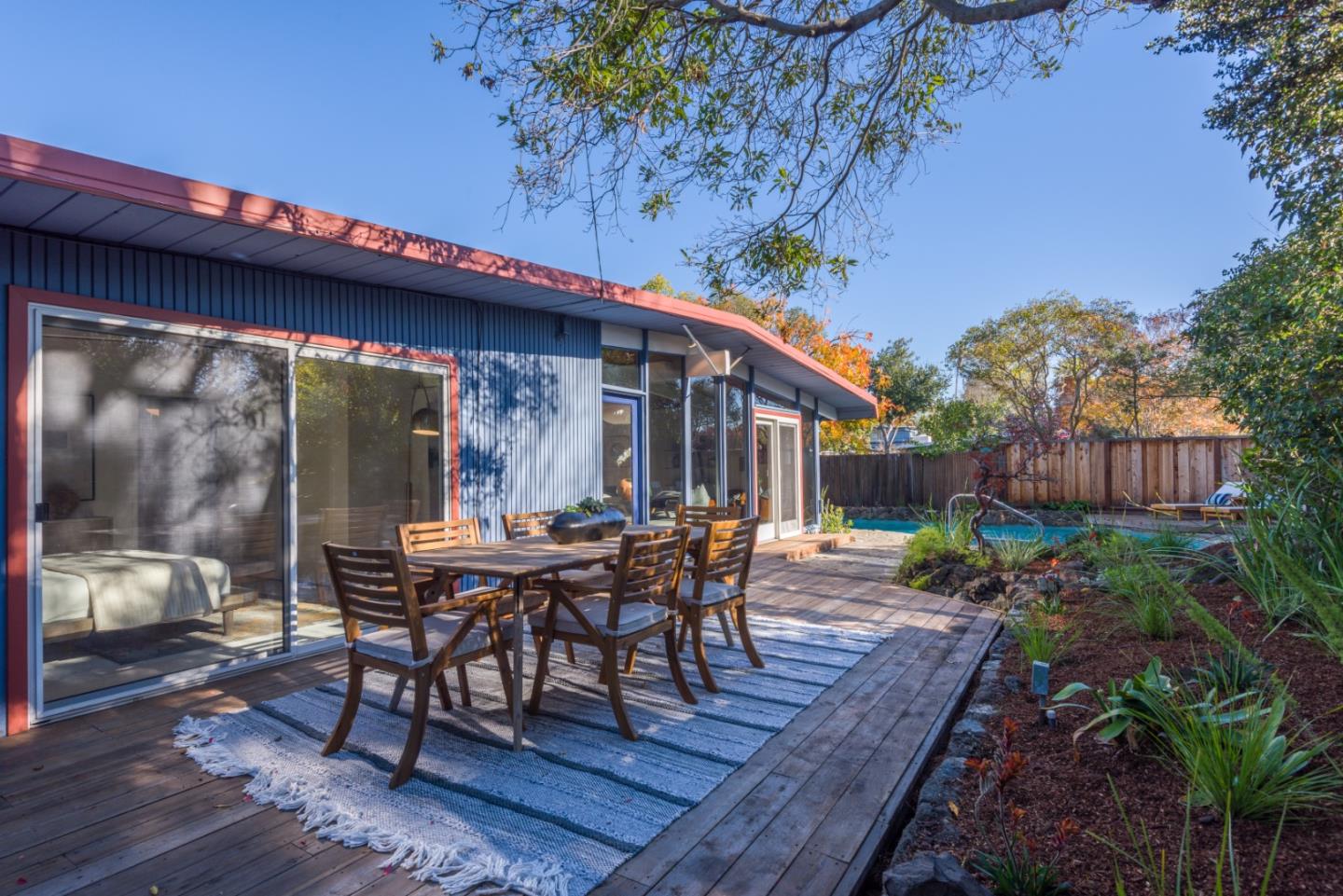 2 Roosevelt Circle Palo Alto, CA 94306 - Photo 2 of 42 a view of a patio with table and chairs with wooden floor and plants