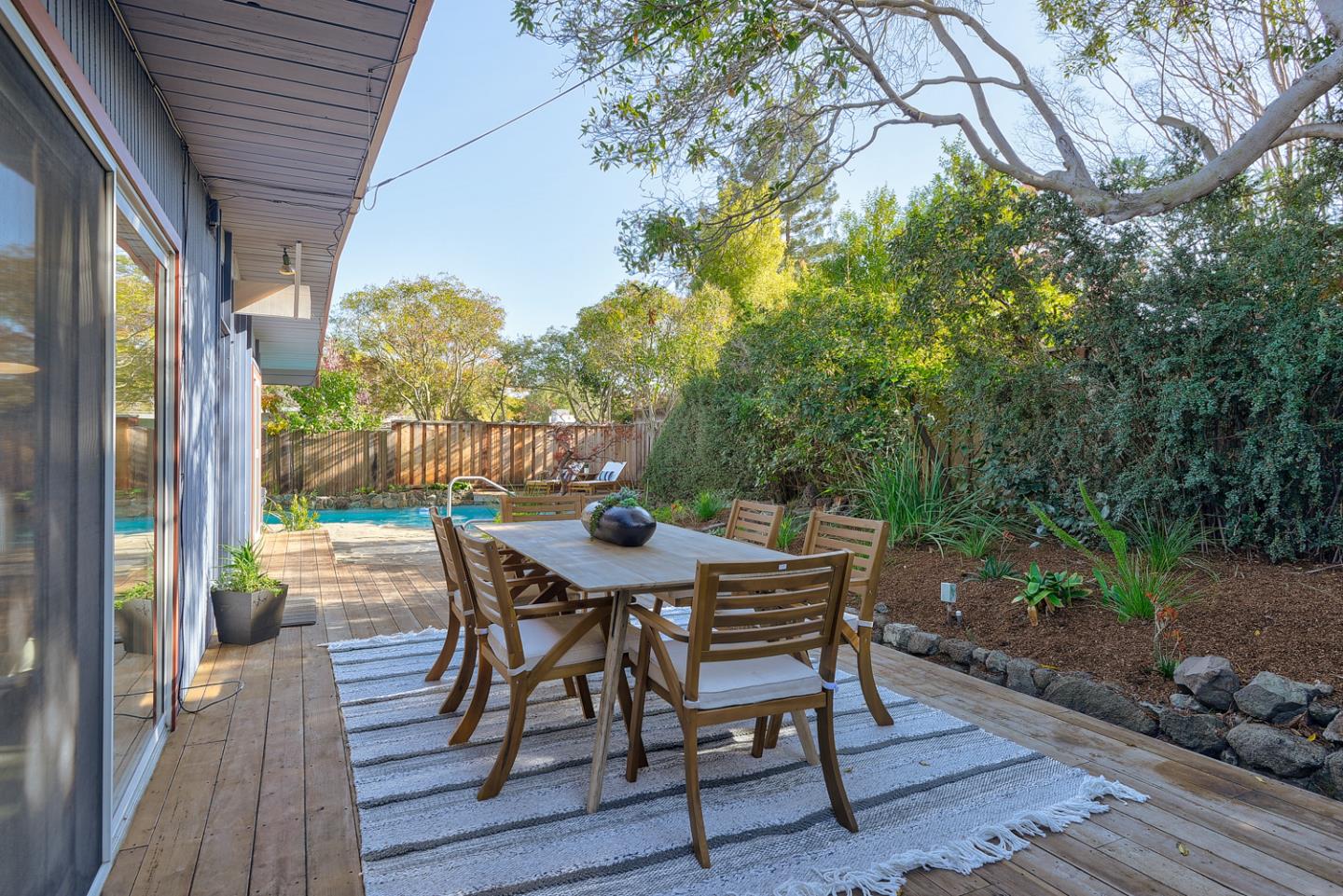 2 Roosevelt Circle Palo Alto, CA 94306 - Photo 31 of 42 a view of a patio with table and chairs and wooden floor