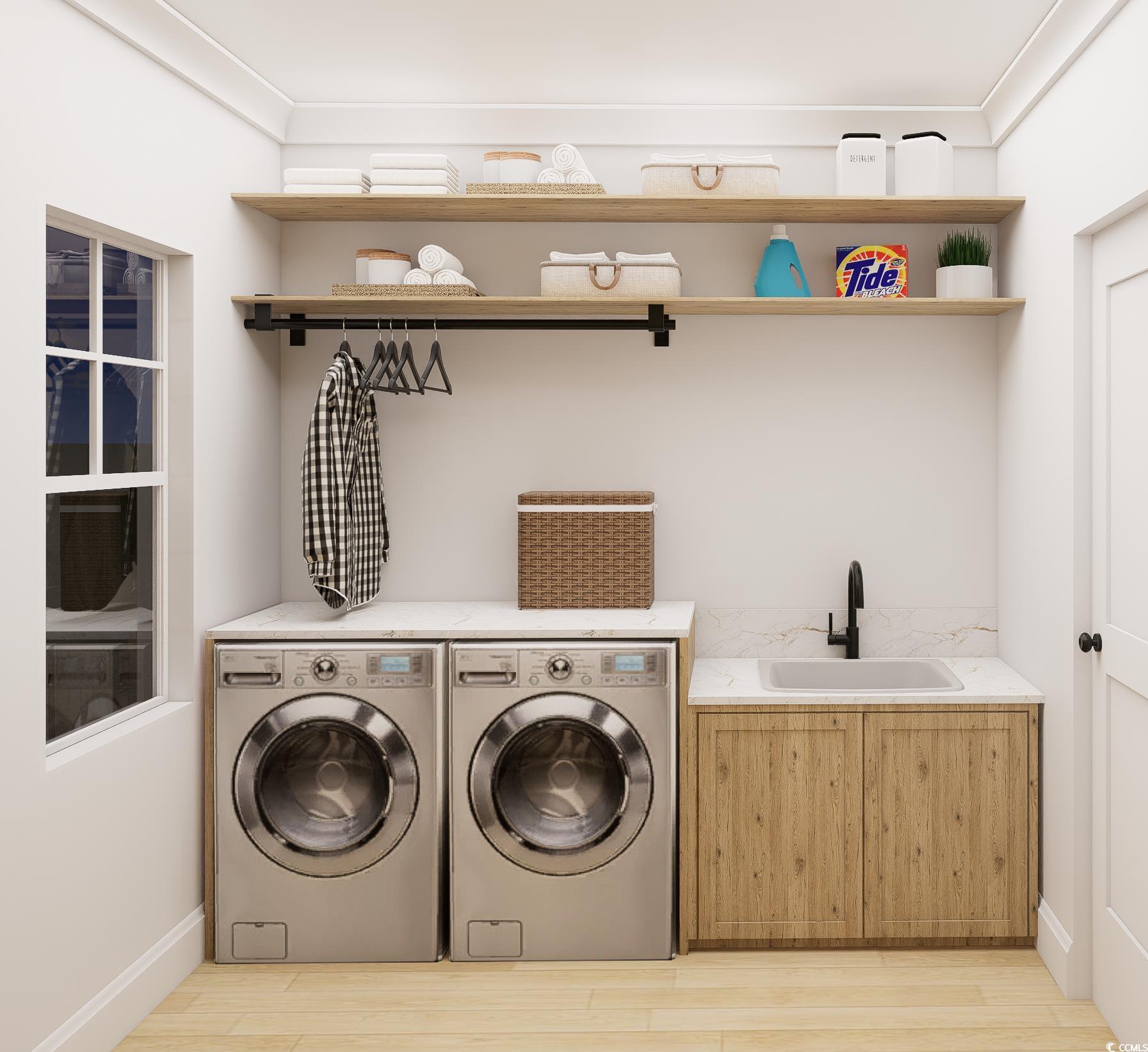 310 King Street Georgetown, SC 29440 - Photo 13 of 23 Laundry area with washing machine and clothes dryer, light wood-type flooring, and crown molding