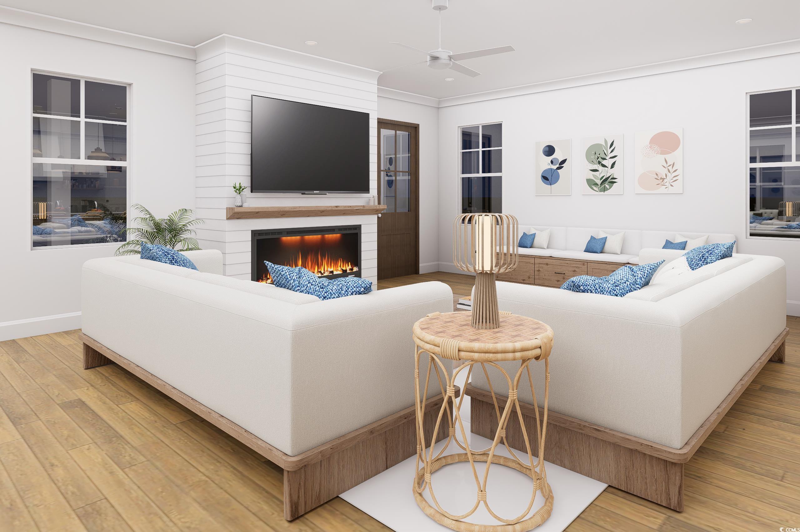 310 King Street Georgetown, SC 29440 - Photo 8 of 23 Living area featuring a fireplace, light wood finished floors, crown molding, and ceiling fan