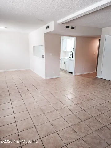 a view of a livingroom with an empty space and a window