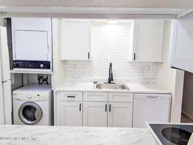 a kitchen with a sink a stove and cabinets