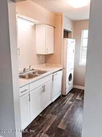 a utility room with cabinets washer and dryer