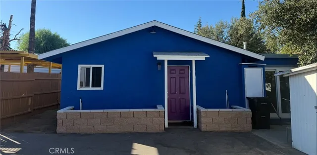 a view of a house with a couches and potted plants