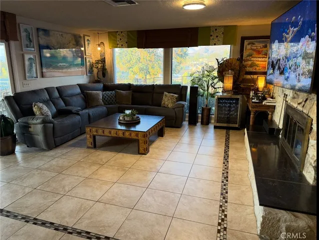 a hallway with painting on the wall and a flat screen tv