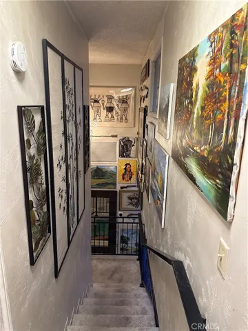 a view of a house with couches chairs and wooden fence