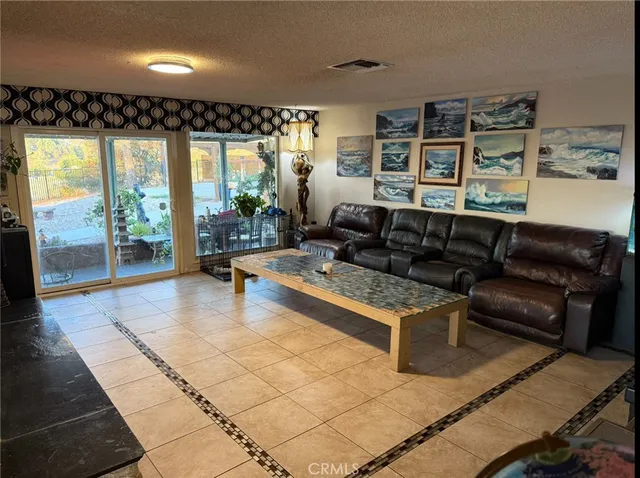 a living room with furniture and a floor to ceiling window