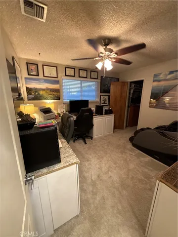 a kitchen with a refrigerator and a stove top oven