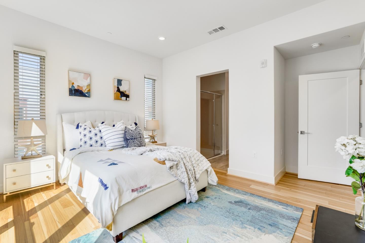 360 Riesling Avenue, Unit 32 Milpitas, CA 95035 - Photo 13 of 32 a bedroom with a bed and wooden floor