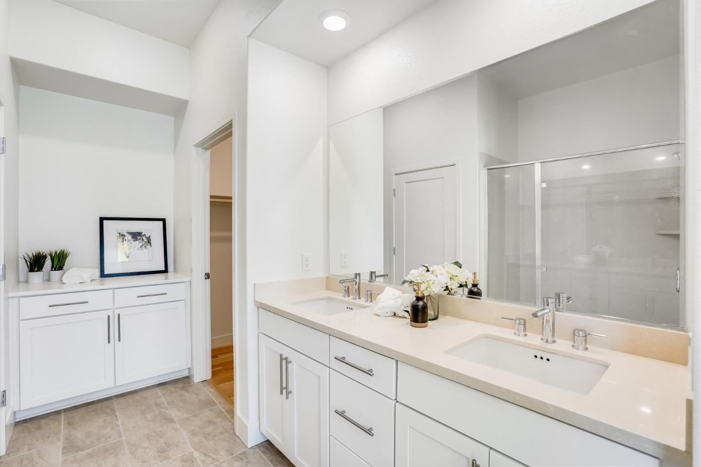 360 Riesling Avenue, Unit 32 Milpitas, CA 95035 - Photo 14 of 32 a bathroom with double vanity sink a mirror and a bathtub