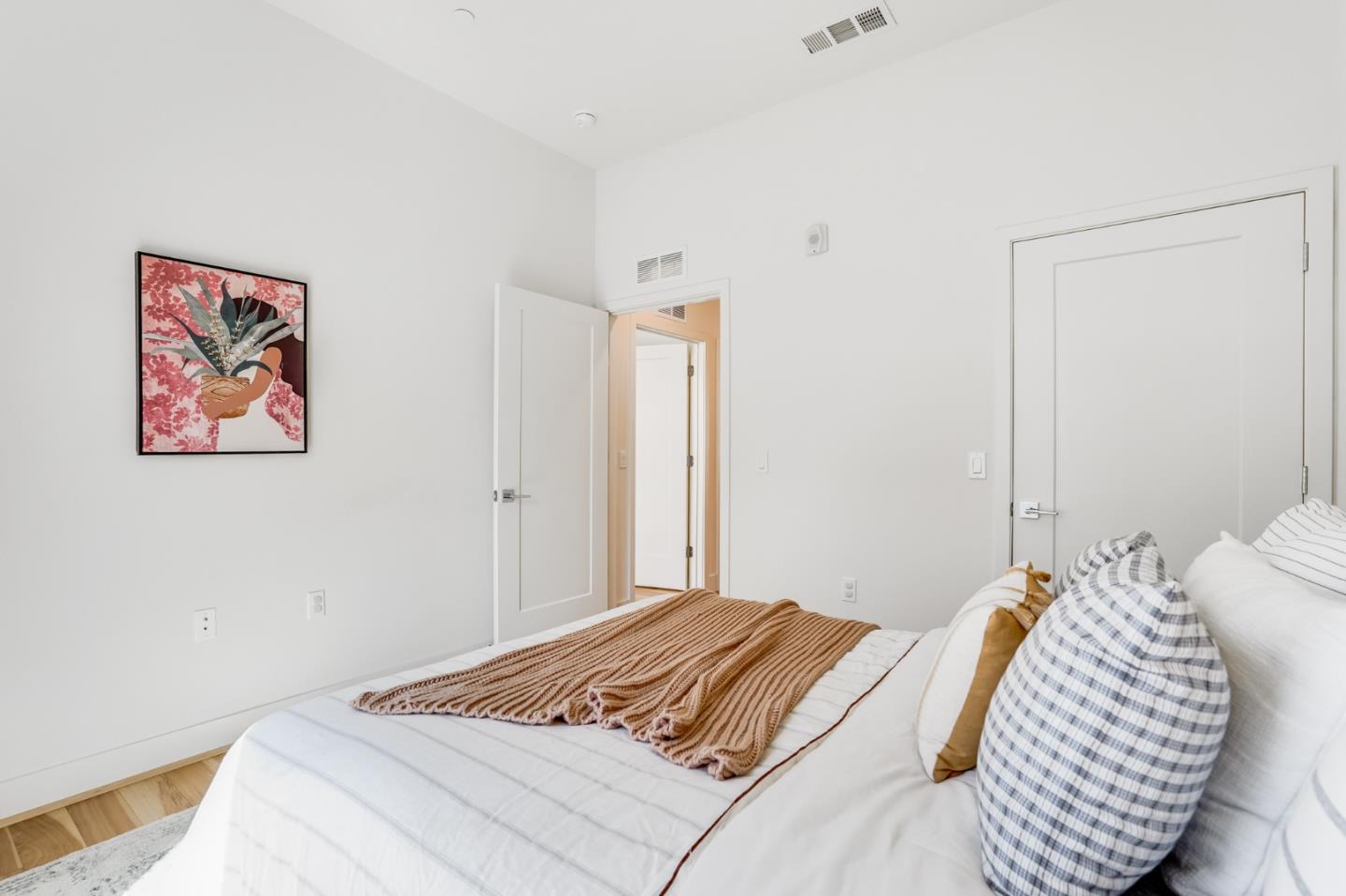 360 Riesling Avenue, Unit 32 Milpitas, CA 95035 - Photo 19 of 32 a bedroom with a bed and a painting on the wall