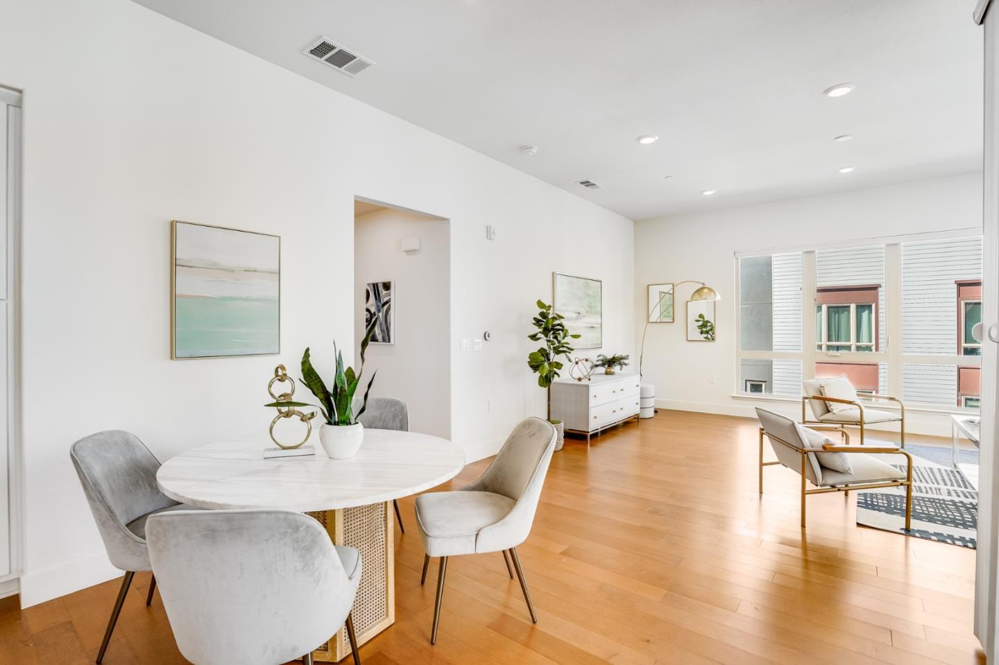 360 Riesling Avenue, Unit 32 Milpitas, CA 95035 - Photo 4 of 32 a view of a dining room with furniture and wooden floor